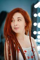 Curious red-haired girl with long dreadlocks. photo