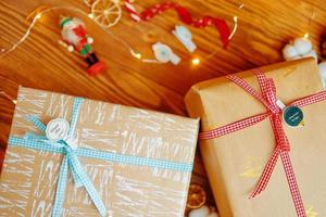 Top view of Christmas gifts and decorations on wooden table. photo