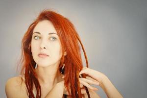 Red-haired girl with long dreadlocks. photo