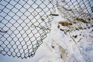 Hole in wire border fence. photo
