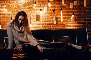 Cute girl sitting on the couch. photo