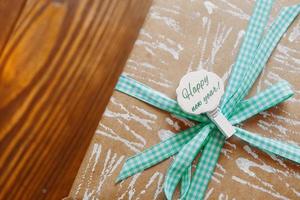 Gift box on wooden table. photo