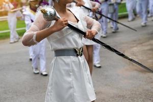 The drum major leads the school orchestra parade with a scepter. Soft and selective focus. photo