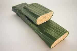 Tempeh Or Tempe is Indonesian traditional food made from fermented soybeans. They are usually wrapped in banana leaves photo