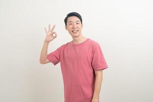 young Asian man thumbs up or ok hand sign photo