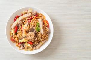 Instant noodles spicy salad on plate photo