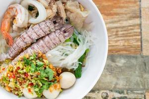 spicy seafood noodles bowl in Thai style photo