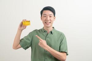 young Asian man holding credit card photo