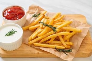 French fries with sour cream and ketchup photo