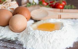 ingredients preparation spaghetti with eggs, tomatoes herbs and spices photo