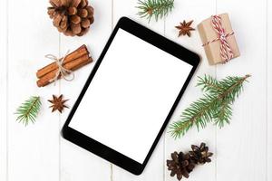 Digital tablet mock up with rustic Christmas wooden background decorations for app presentation. top view with copy space photo