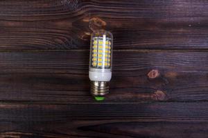 LED bulb on the wooden background, Light Effect photo