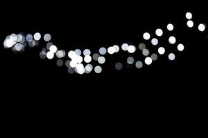Abstract bokeh of white city lights on black background. defocused and blurred many round light photo