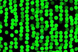 Unfocused abstract green bokeh on black background. defocused and blurred many round light photo