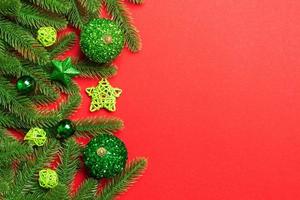 Set of festive balls, fir tree and Christmas decorations on colorful background. Top view of New Year ornament concept with copy space photo