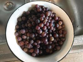 Squeezing grape juice with a screw manual meat grinder photo