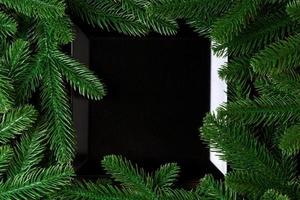 Top view served plate with green fir tree branches. Holiday dinner concept with copy space photo
