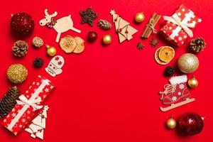 Top view of Christmas decorations on red background. New Year holiday concept with copy space photo