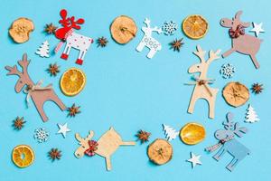 Top view of holiday decorations and toys on blue background. Christmas ornament concept with empty space for your design photo