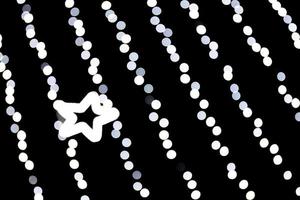 Unfocused abstract white bokeh with star of light on black background. defocused and blurred many round light photo