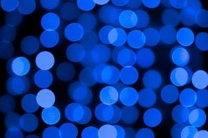 Unfocused abstract colourful bokeh black background. defocused and blurred many round blue light photo