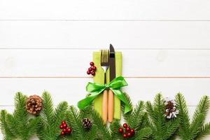 Top view of festive cutlery on new year wooden background. Christmas decorations with empty space for your design. Holiday dinner concept photo