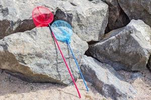 fishing net or butterfly net on a stone near the beach photo