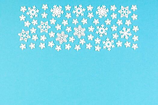 Set of white snowflakes on colorful background. Top view of Christmas ornament. New Year time concept with empty space for your design photo