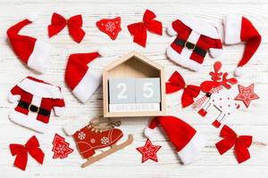 Top view of calendar on Christmas wooden background. The twenty fifth of December. New Year toys and decorations. Holiday concept photo