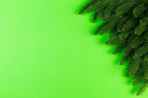 Top view of colorful festive background made of fir tree branch. Christmas holiday concept with copy space photo