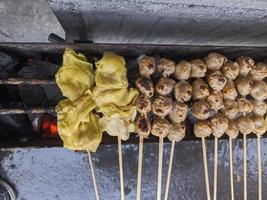 grilled meatballs. traditional street local food in indonesia where the manufacturing process is grilled on hot charcoal photo