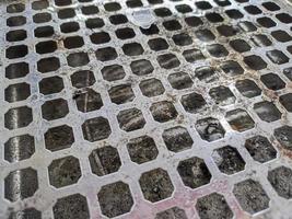 perforated circle pattern in aluminum iron which is used as a cigarette ashtray photo