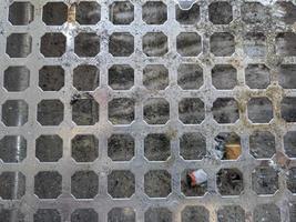 perforated circle pattern in aluminum iron which is used as a cigarette ashtray photo