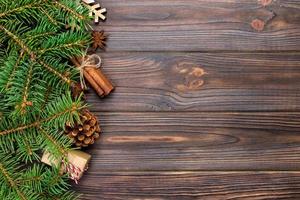 Christmas background with fir tree and gift box on wooden table. Top view with copy space for your design photo