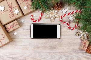 Smart phone mock up with rustic Christmas decorations for app presentation. View from above photo