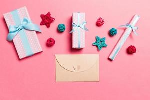 Top view of envelope on pink background. New Year decorations. Christmas holiday concept photo