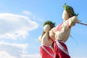 Closeup scarecrow in countryside of Ukraine. Scarecrow against the sky photo