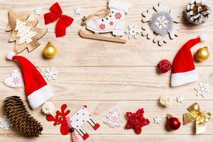 Top view of Christmas decorations and toys on wooden background. Copy space. Empty place for your design. New Year concept photo