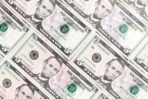 Close up of 5 dollar bills as a background. Amarican dollars pattern. Top view of business concept photo