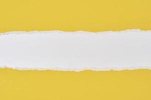 Torn ripped paper edge with a copy space, white and yellow color background photo