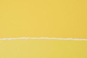 Torn ripped paper edge with a copy space, yellow color background photo