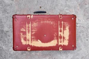 Vintage retro red suitcase, closeup. Old case photo
