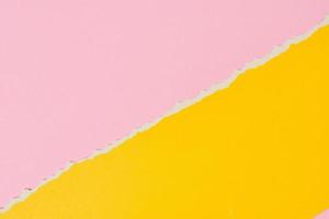 Torn ripped paper edge with a copy space, pink and yellow color background photo