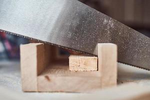 Process of sawing a wooden board. Concept of DIY woodwork and furniture making photo