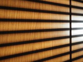 blinds shadow on wooden wall background photo