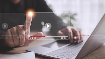 man using mouse and keyboard for streaming online, watching video on internet, live concert, show or tutorial photo