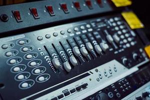 Audio music mixer console on a black background. Sound studio mixing desk photo