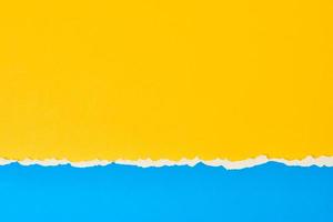 Torn ripped paper edge with a copy space, color blue and yellow background photo