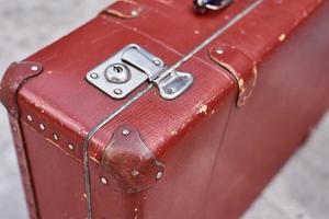 Part of vintage retro suitcase. Closeup view of lock on old suit case photo