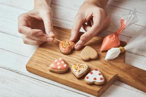 Decorating gingerbread cookies with icing photo